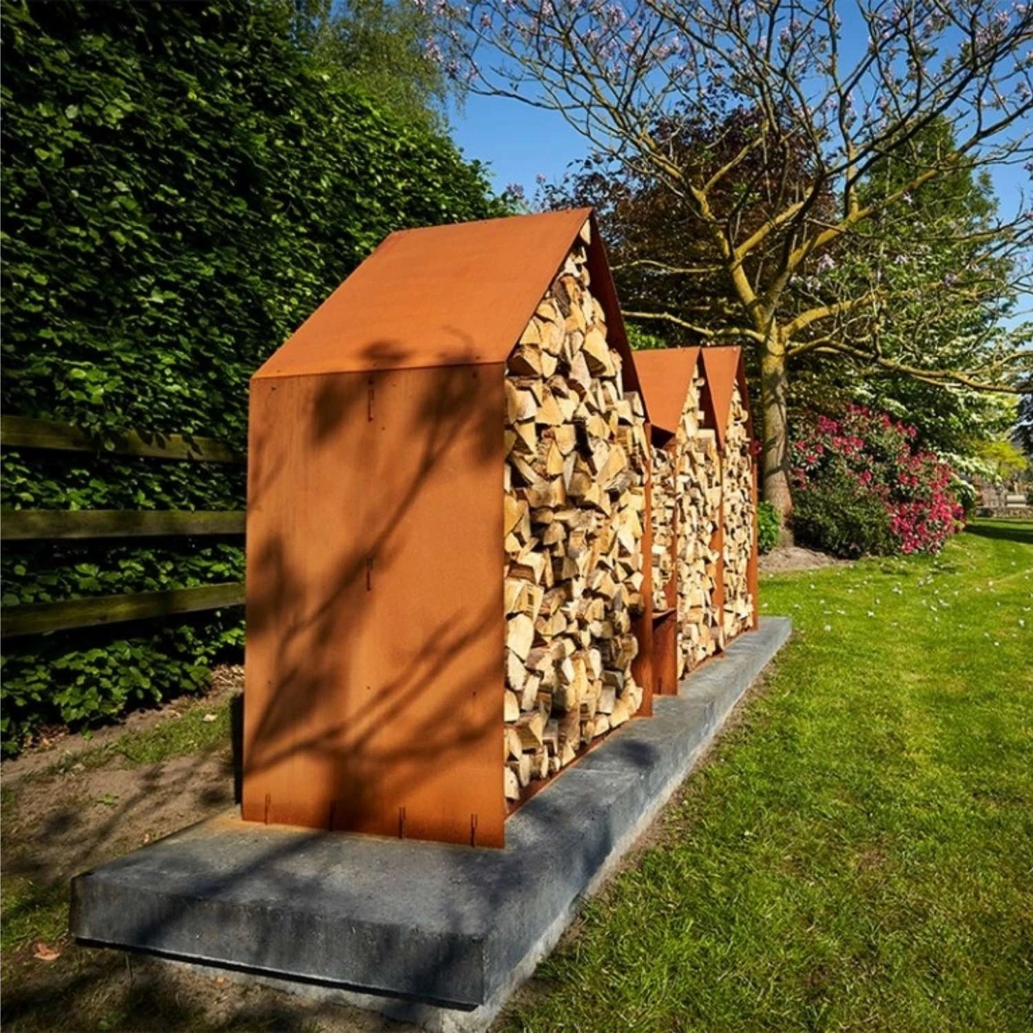 Bruges 3 Houses Log Storage, a spacious and durable solution for storing firewood in outdoor spaces like gardens and patios.
